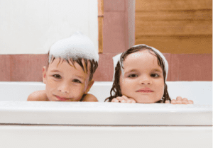 A small boy and girl are bathing